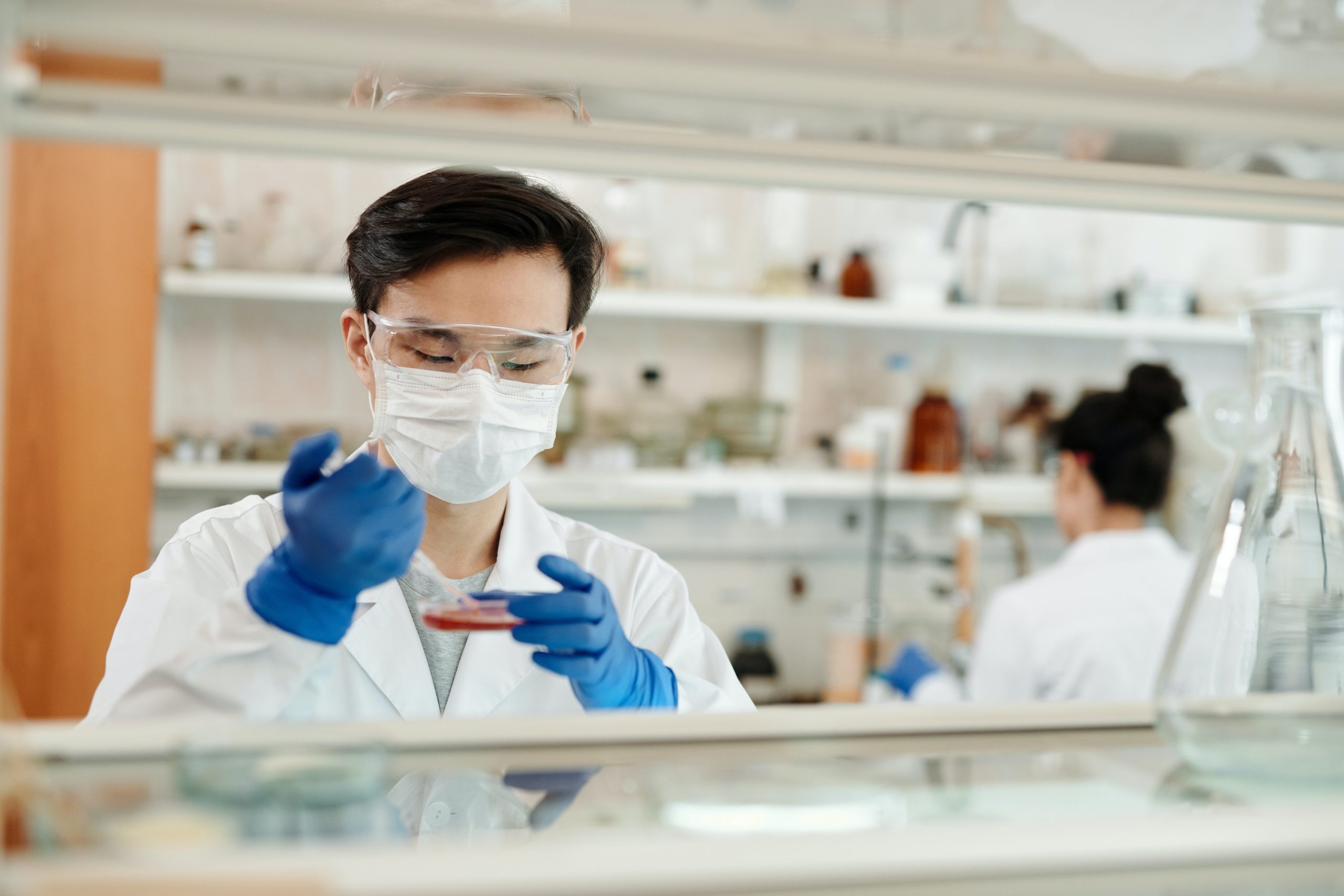 Clinical Microbiology - Scientist holding petri dish